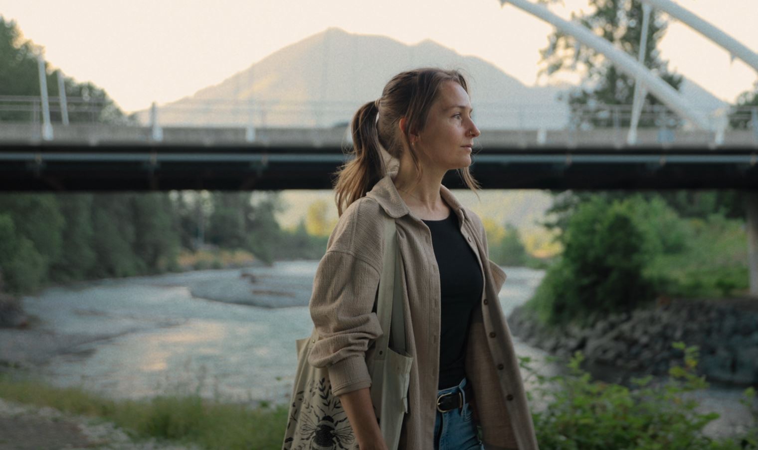 Riverside walk under the bridge with mountain views